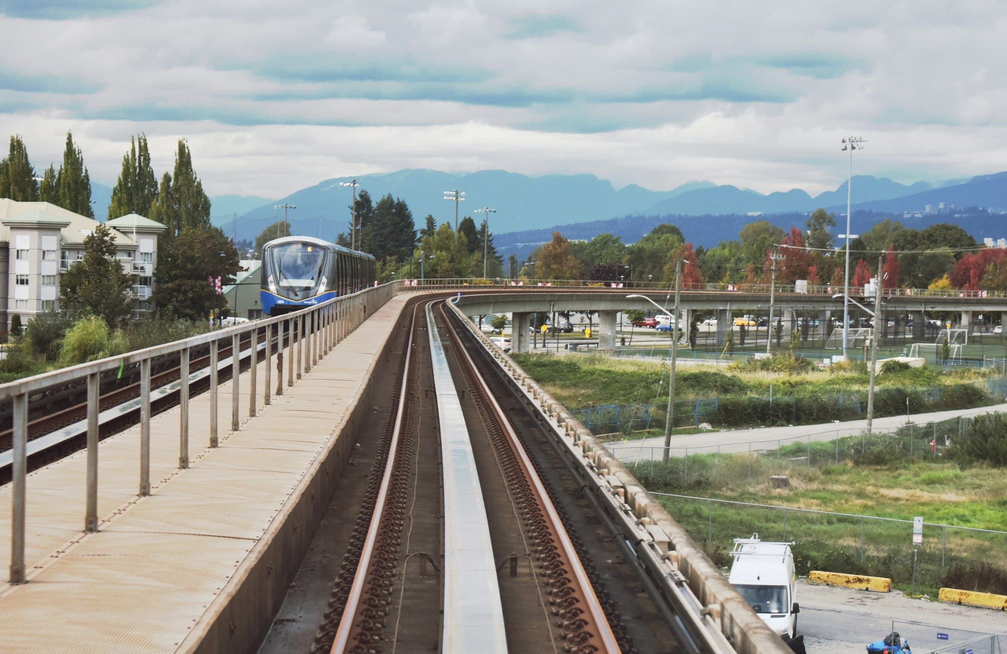 SkyTrain tracks in Surrey with the mountains behind