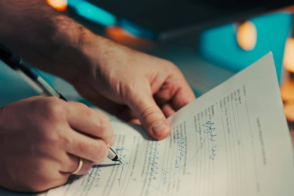 Buyer reading and signing a pre-sale purchase contract